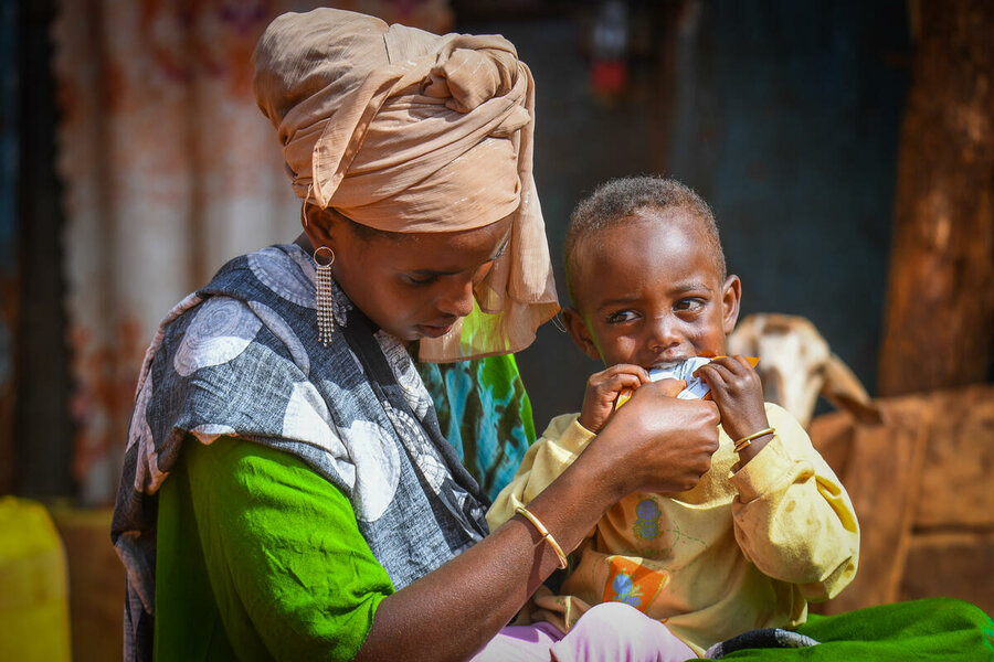 エチオピア:息子のリベン・ケフェラちゃんに、国連WFPの支援による栄養補助食品を与える母親のシェドルさん。Photo: WFP/Michael Tewelde
